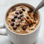 Spoonful of soft protein cookie dough mug with melty chips
