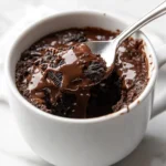 Spoonful of warm Oreo mug cake with melted chocolate